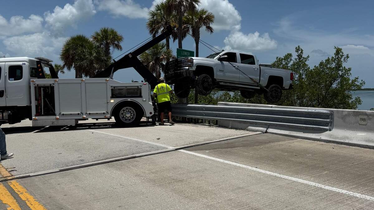 A tow truck pulls a Chevrolet pickup truck from the Harris Gap Channel on Lower Sugarloaf Key on Saturday, July 4, 2026.